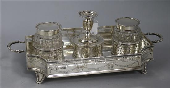 A George V pierced silver two handled inkstand, with two wells and central taperstick, William Hutton & Sons, Sheffield, 1911,